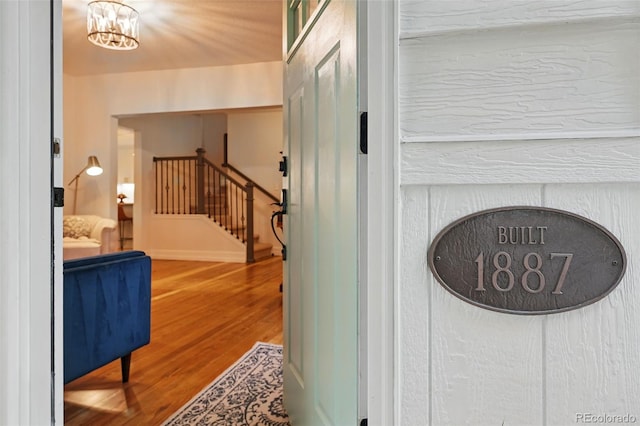 6830 Lamar St, Arvada, CO 80003 - detailed view of wood finished floors and a chandelier