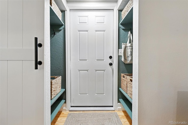 6830 Lamar St, Arvada, CO 80003 - mudroom with light wood-style floors and a textured wall