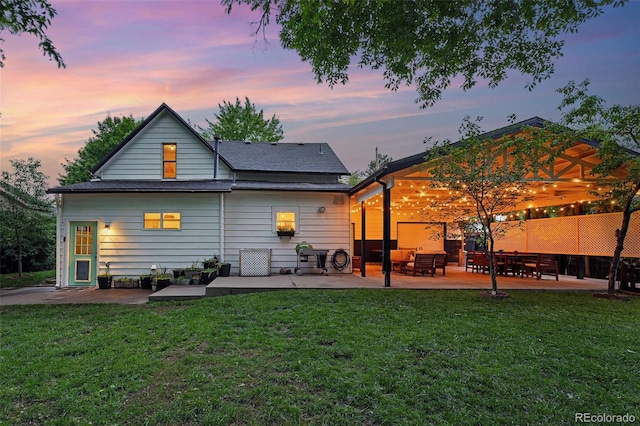 6830 Lamar St, Arvada, CO 80003 - rear view of property featuring a patio area and a lawn
