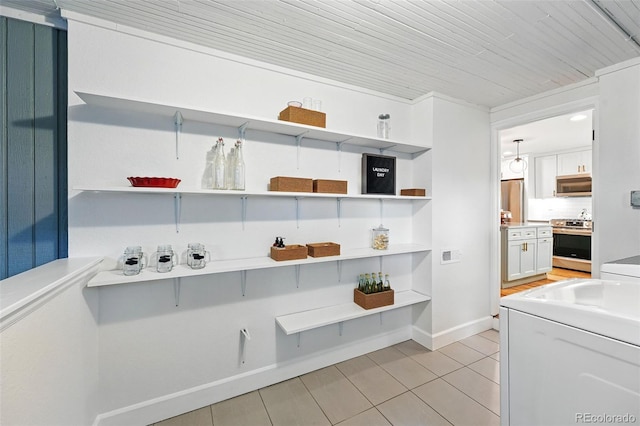 6830 Lamar St, Arvada, CO 80003 - kitchen featuring open shelves, appliances with stainless steel finishes, and light tile patterned floors