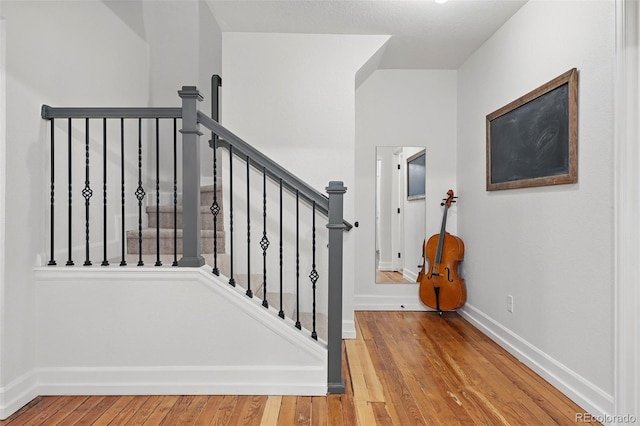 6830 Lamar St, Arvada, CO 80003 - stairway featuring wood finished floors and baseboards