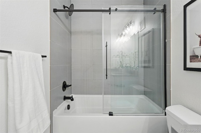 6830 Lamar St, Arvada, CO 80003 - full bathroom featuring toilet and bath / shower combo with glass door