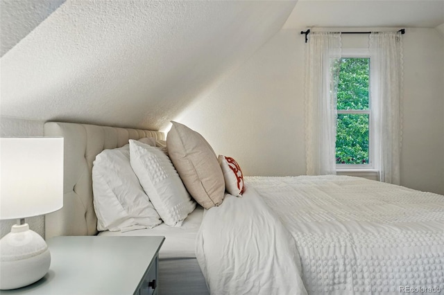 6830 Lamar St, Arvada, CO 80003 - bedroom featuring vaulted ceiling and a textured ceiling