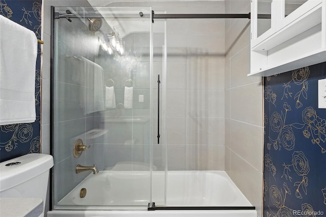 6830 Lamar St, Arvada, CO 80003 - full bathroom featuring bath / shower combo with glass door and toilet
