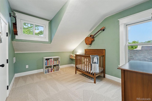 6830 Lamar St, Arvada, CO 80003 - carpeted bedroom with lofted ceiling, multiple windows, baseboards, and a nursery area