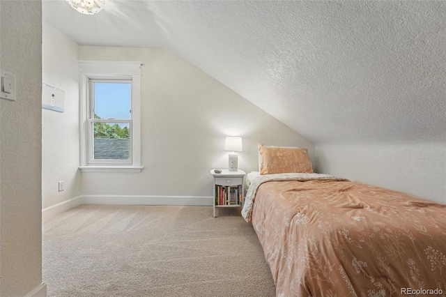 6830 Lamar St, Arvada, CO 80003 - carpeted bedroom featuring lofted ceiling, a textured ceiling, and baseboards