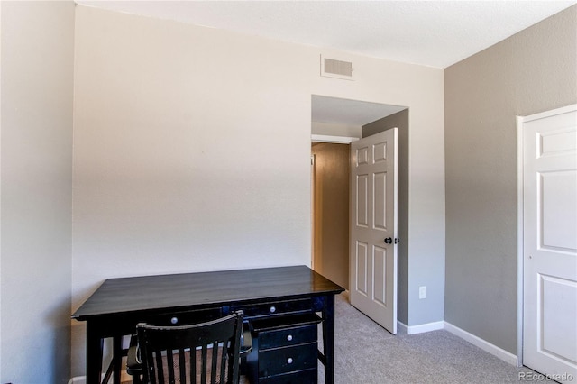 office area featuring light carpet, visible vents, and baseboards