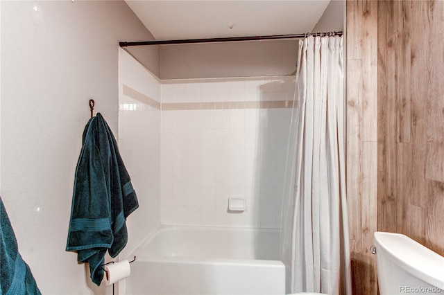 full bathroom featuring shower / tub combo and toilet