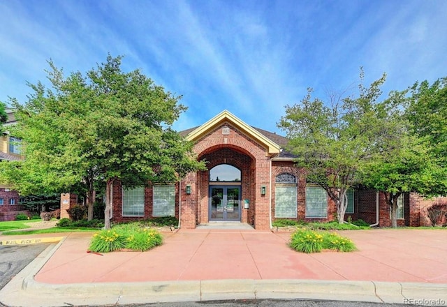 exterior space featuring french doors and brick siding