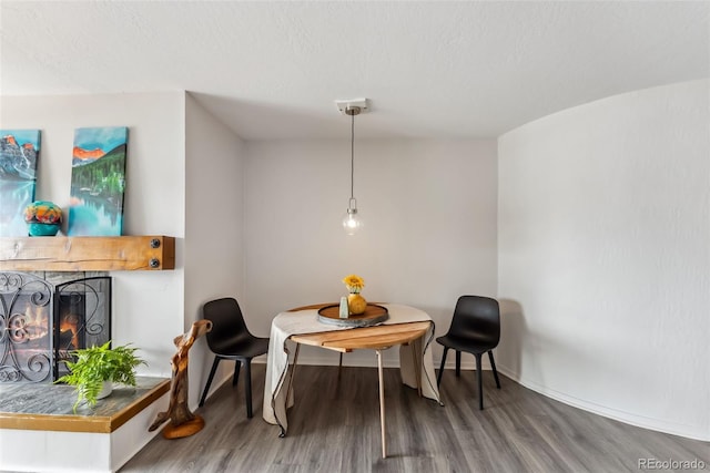 311 W La Bonte St Unit 306, Dillon, CO 80435 - dining room with wood finished floors, a lit fireplace, and baseboards