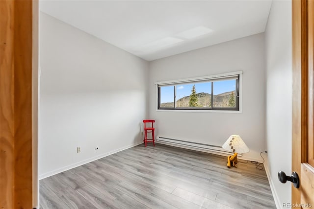 311 W La Bonte St Unit 306, Dillon, CO 80435 - empty room featuring wood finished floors, a baseboard heating unit, and baseboards