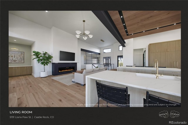 kitchen with an inviting chandelier, high vaulted ceiling, decorative light fixtures, wooden ceiling, and light wood-type flooring