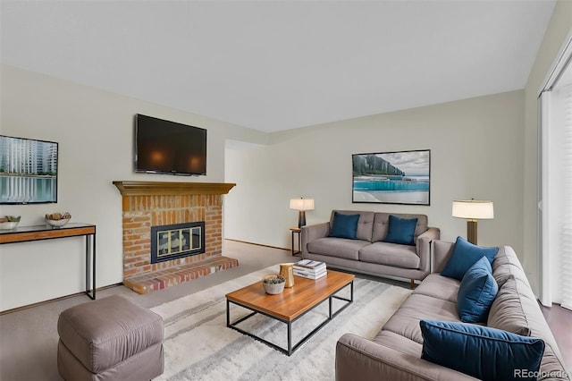living area featuring a brick fireplace and baseboards