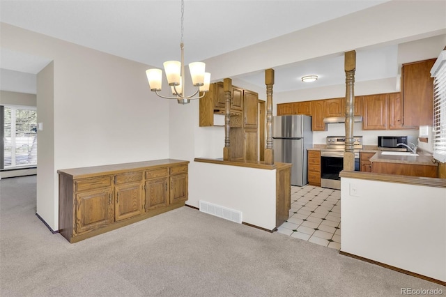 kitchen featuring appliances with stainless steel finishes, under cabinet range hood, brown cabinetry, and light carpet