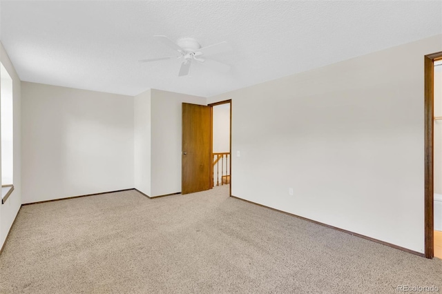 unfurnished room with ceiling fan, carpet floors, and baseboards