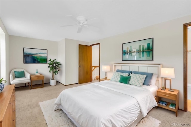 bedroom featuring light carpet, a ceiling fan, and baseboards