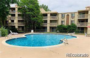 1302 S Parker Rd Unit 127, Denver, CO 80231 - community pool featuring a patio area