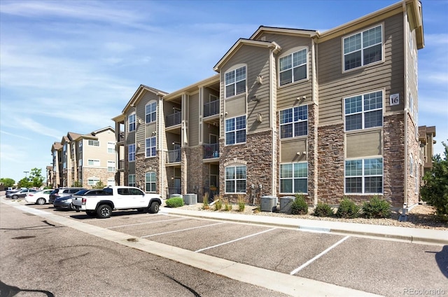 9227 Rolling Way Unit 201, Parker, CO 80134 - view of building exterior featuring uncovered parking and central AC unit