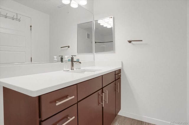 9227 Rolling Way Unit 201, Parker, CO 80134 - bathroom with vanity, wood finished floors, and baseboards