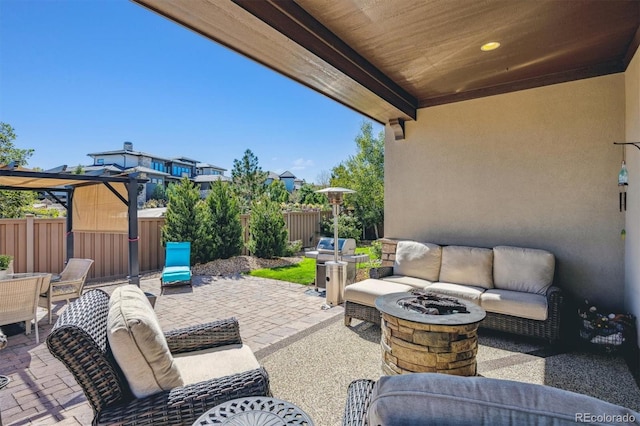 view of patio / terrace with an outdoor living space with a fire pit