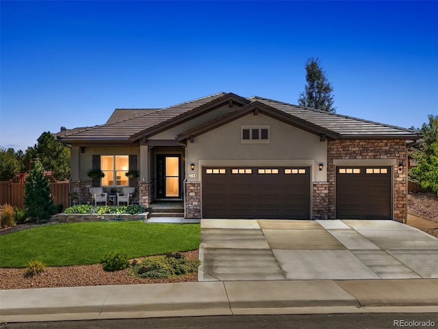 view of front facade featuring a front lawn and a garage