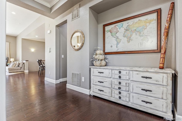 hall featuring dark hardwood / wood-style flooring and crown molding