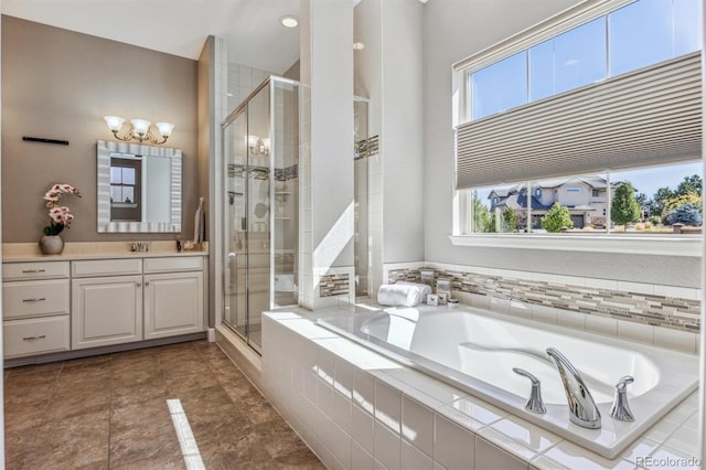 bathroom featuring vanity and shower with separate bathtub