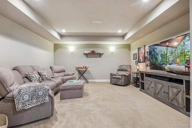 living room with light carpet and a tray ceiling