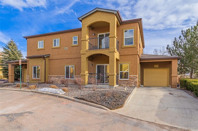 view of front of home featuring a balcony and a garage