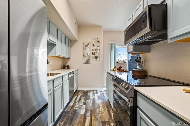 kitchen with sink, dark hardwood / wood-style floors, and appliances with stainless steel finishes