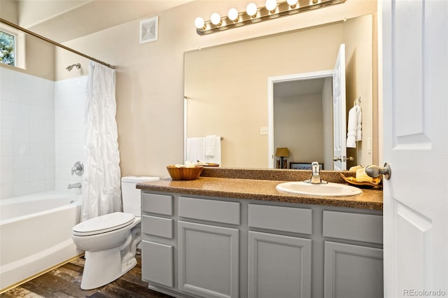 full bathroom featuring hardwood / wood-style floors, vanity, toilet, and shower / bath combo with shower curtain