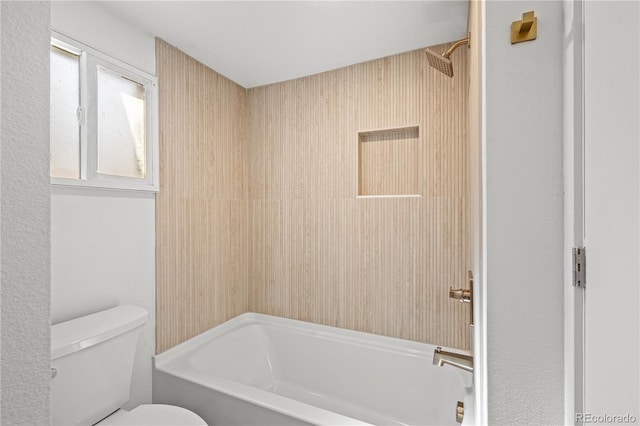 bathroom featuring toilet and shower / bathing tub combination