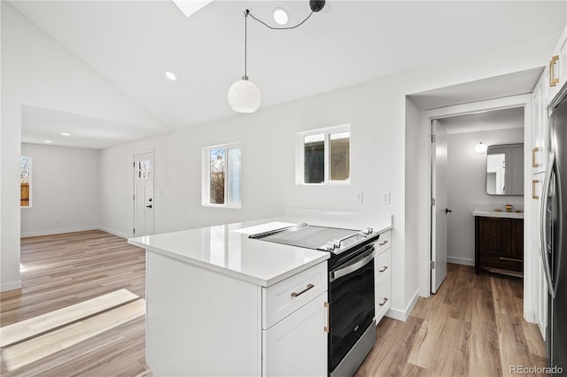 kitchen with white cabinetry, stainless steel range with electric stovetop, decorative light fixtures, vaulted ceiling, and light wood-type flooring