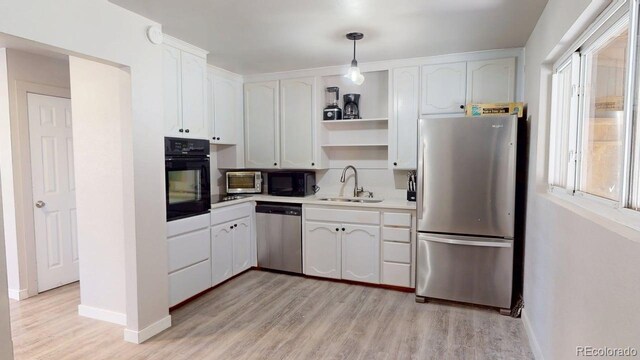 2533 E 90th Pl, Thornton, CO 80229 - kitchen with open shelves, a sink, white cabinets, black appliances, and light wood finished floors