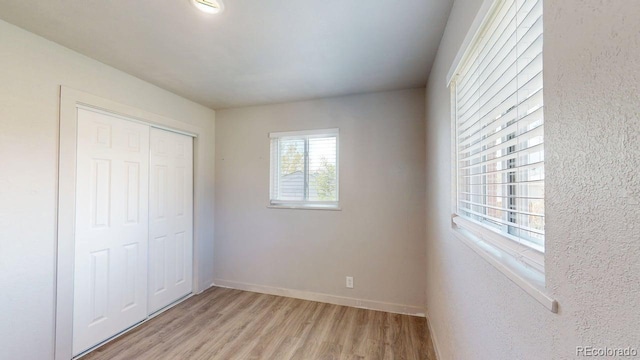 2533 E 90th Pl, Thornton, CO 80229 - unfurnished bedroom featuring baseboards, a closet, and light wood-type flooring