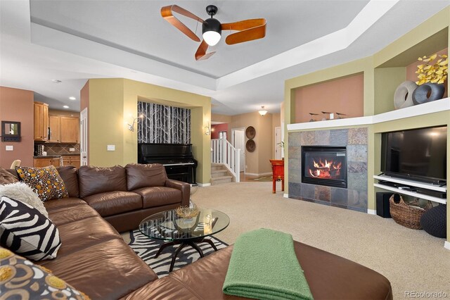 2488 Lake Vista Dr, Broomfield, CO 80023 - living area with a tiled fireplace, ceiling fan, stairs, carpet floors, and recessed lighting