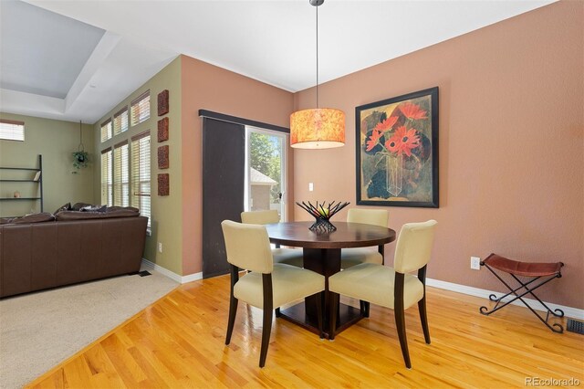2488 Lake Vista Dr, Broomfield, CO 80023 - dining space featuring light wood-style flooring and a tray ceiling