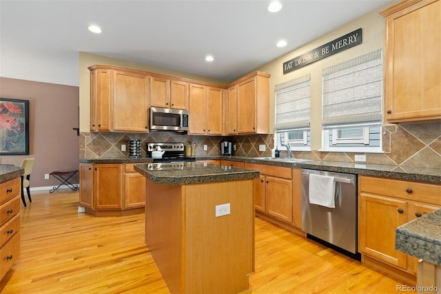 2488 Lake Vista Dr, Broomfield, CO 80023 - kitchen featuring appliances with stainless steel finishes, light wood-type flooring, a center island, backsplash, and recessed lighting