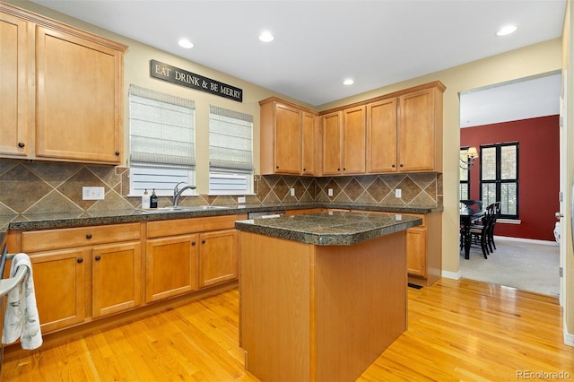 2488 Lake Vista Dr, Broomfield, CO 80023 - kitchen with tile countertops, light wood finished floors, a kitchen island, decorative backsplash, and recessed lighting
