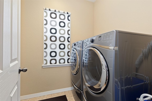 2488 Lake Vista Dr, Broomfield, CO 80023 - laundry area featuring washer and clothes dryer and tile patterned floors