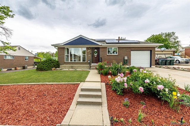 10478 Ogden St, Northglenn, CO 80233 - view of front facade with a garage, brick siding, roof mounted solar panels, concrete driveway, and a front lawn