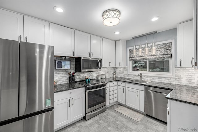10478 Ogden St, Northglenn, CO 80233 - kitchen with appliances with stainless steel finishes, a sink, dark stone counters, white cabinetry, and recessed lighting