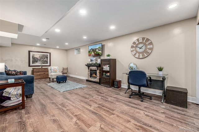 10478 Ogden St, Northglenn, CO 80233 - office area with recessed lighting, wood finished floors, baseboards, and a stone fireplace