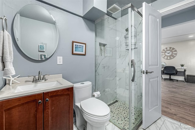10478 Ogden St, Northglenn, CO 80233 - bathroom with a marble finish shower, vanity, and toilet