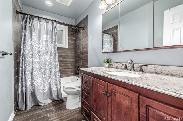 10478 Ogden St, Northglenn, CO 80233 - bathroom featuring toilet, vanity, wood finished floors, and shower / tub combo
