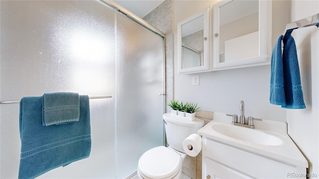 bathroom with toilet, walk in shower, and vanity