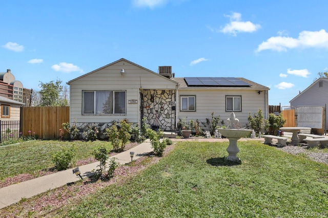 view of front of house with roof mounted solar panels and central air condition unit