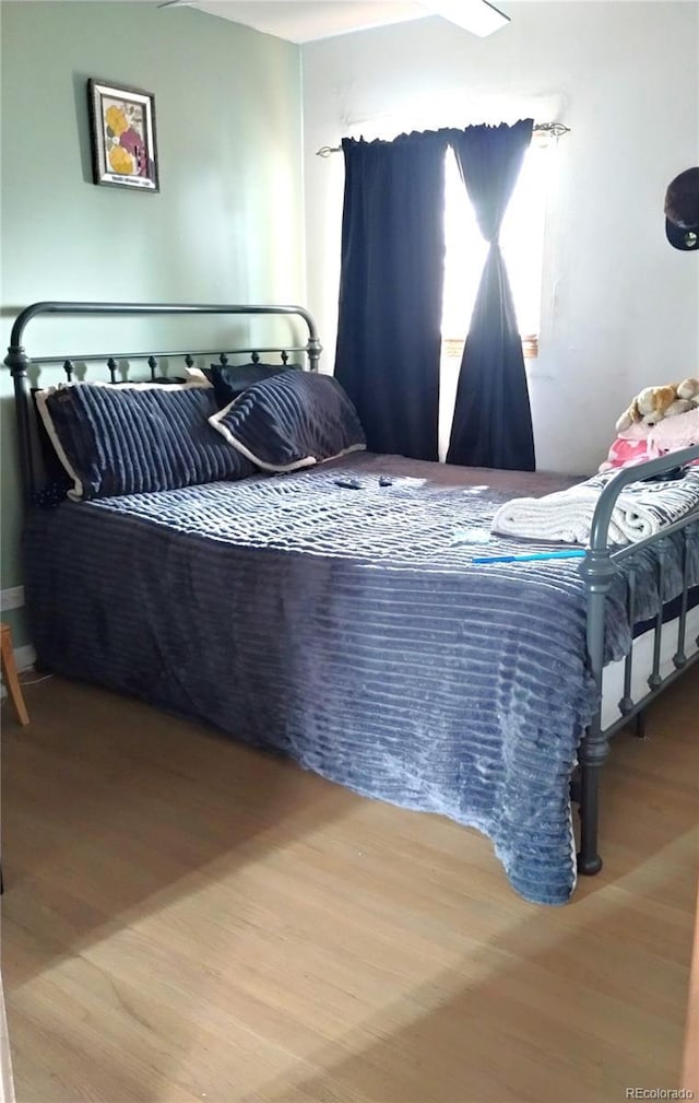 bedroom with wood finished floors