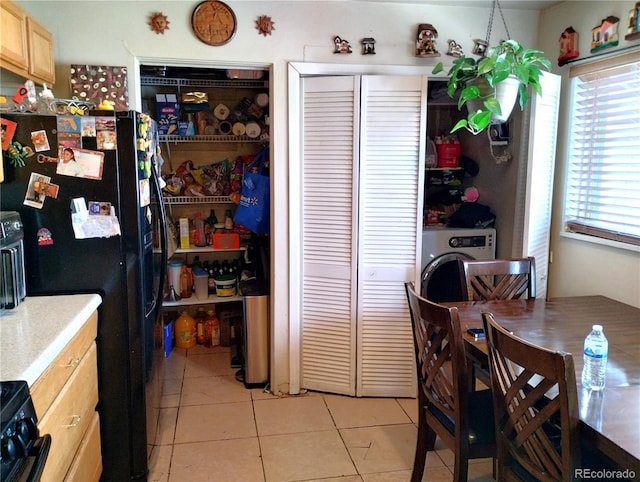 dining space with washer / dryer and light tile patterned floors