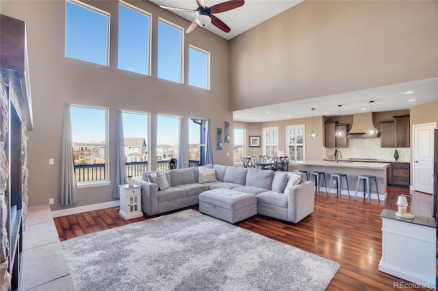 8726 Gardenia Cir, Arvada, CO 80005 - living room with ceiling fan, dark wood-type flooring, a towering ceiling, and recessed lighting